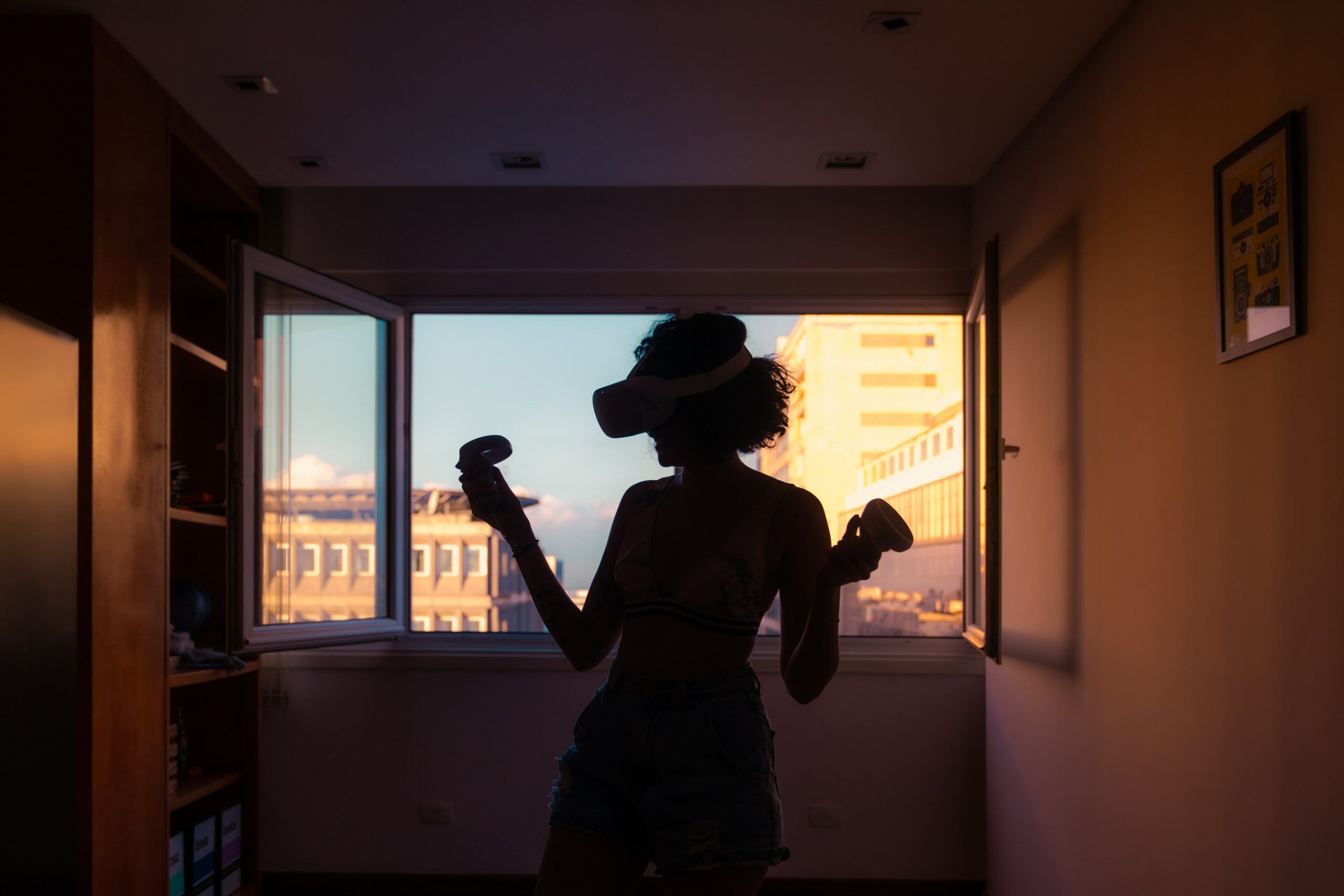 Women wearing a virtual reality headset, standing in a room